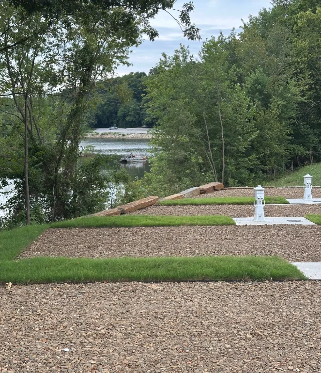 Level gravel sites with lighthouse power pedestals above the lake