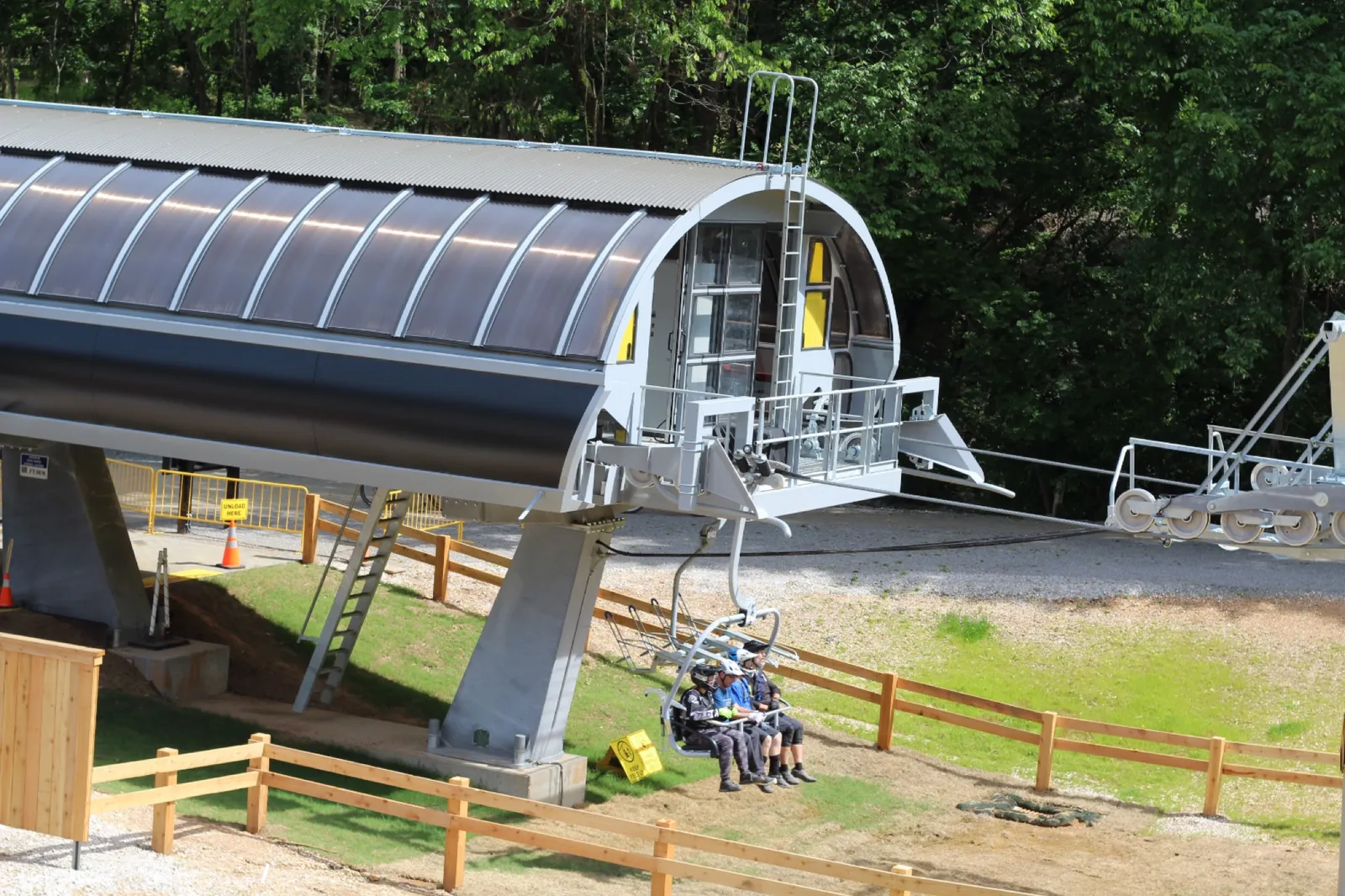 Mountain bikers and their bikes traveling uphill on the OZ Trails chairlift