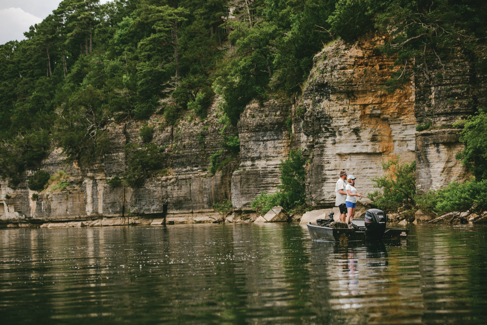 Anglers fishing beside the limestone bluffs of Beaver Lake