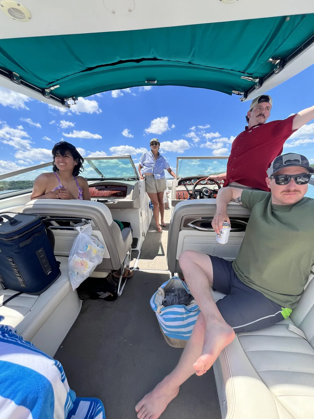 Friends relaxing on a boat on Beaver Lake on a clear day