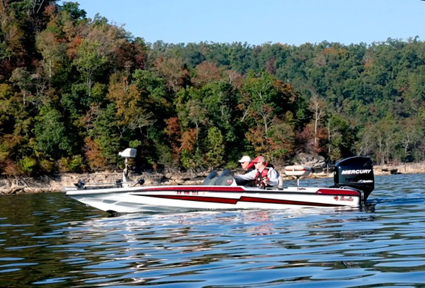 A boat moving across the open water of Beaver Lake