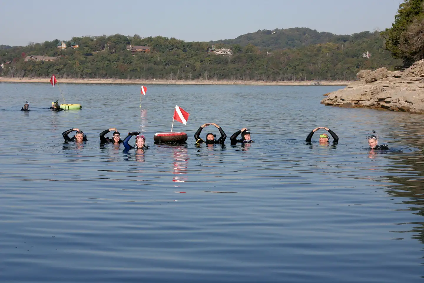 Scuba divers together in the clear water of Beaver Lake