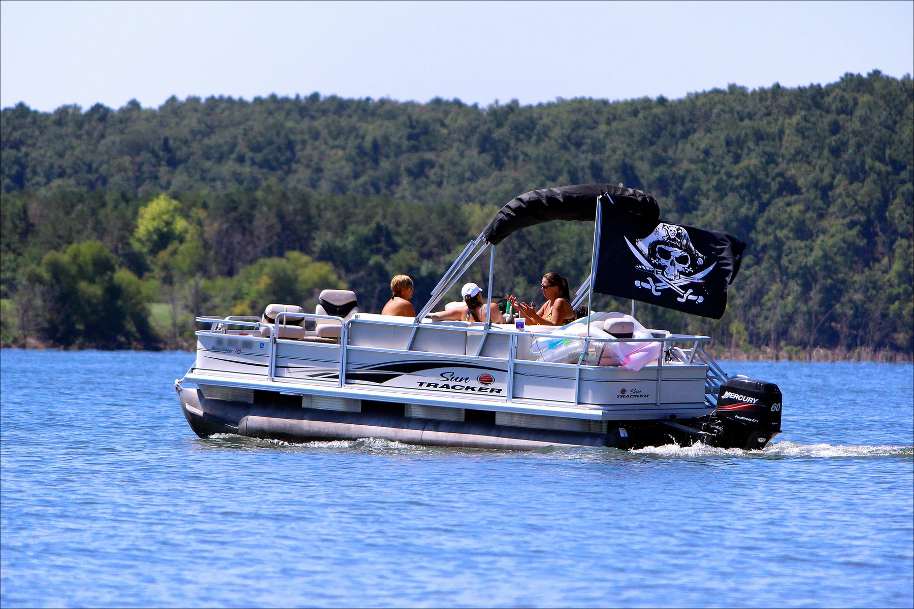 Friends riding together on a pontoon boat at Beaver Lake